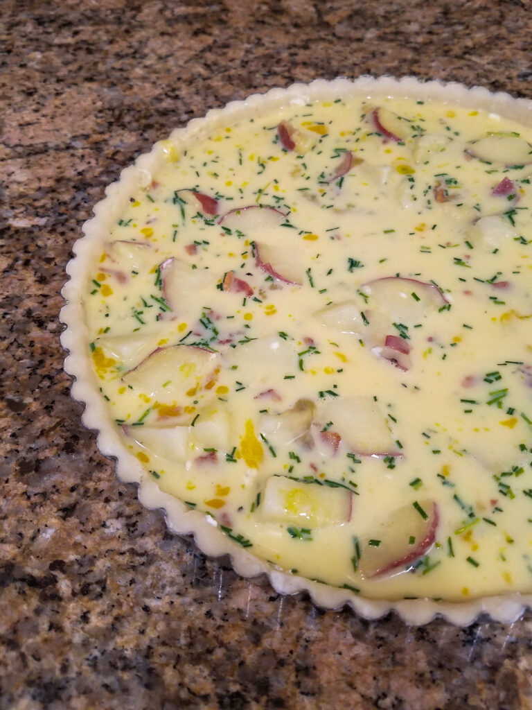Shot of the quiche put together before baking.