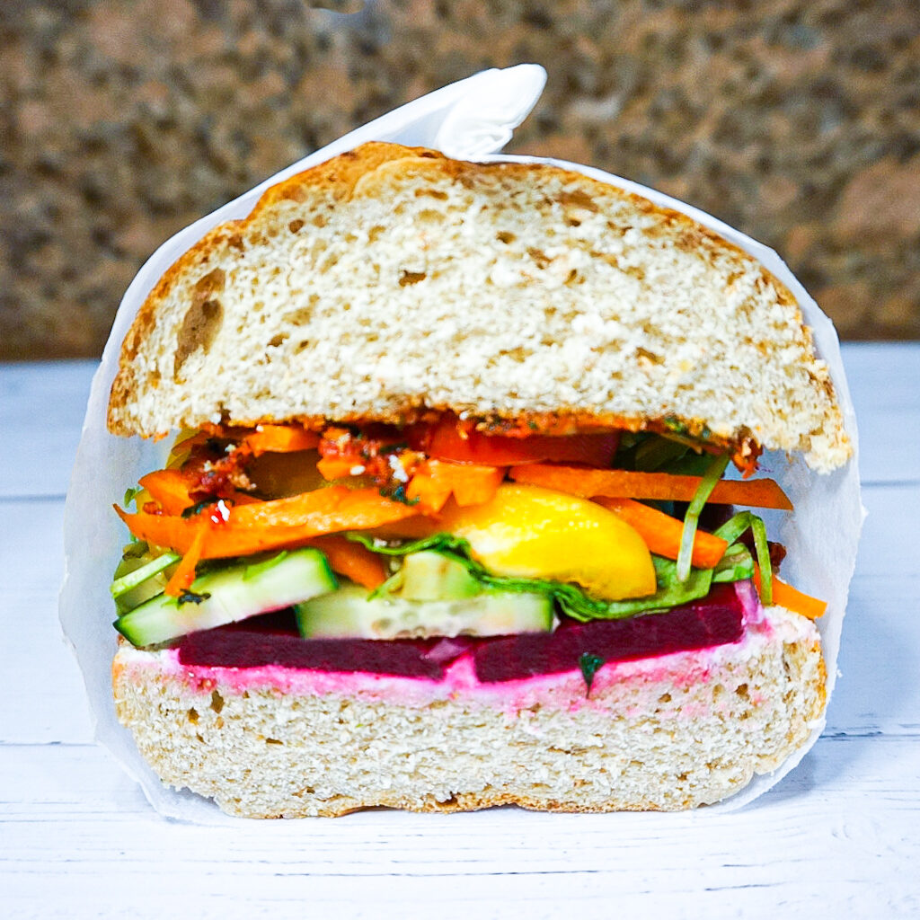 Cross cut shot of the rainbow veggie sandwich.