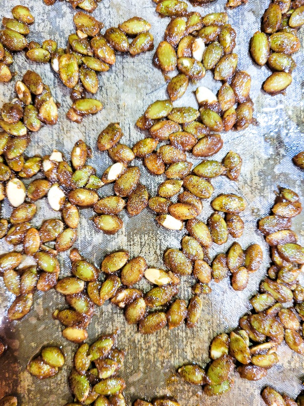 Candied pumplin seeds cooling on a sheet tray.