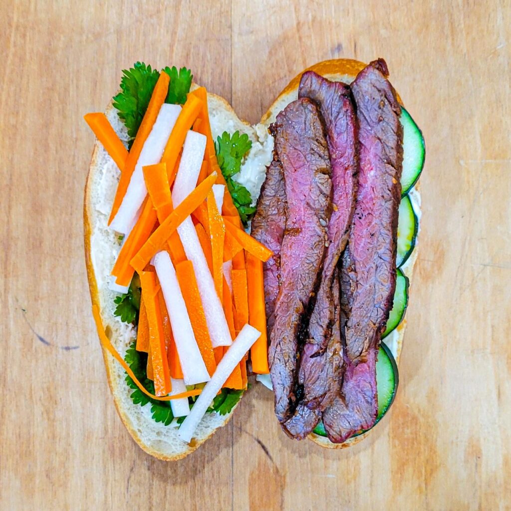 Assembled grilled banh mi sandwich before closing both side together. 